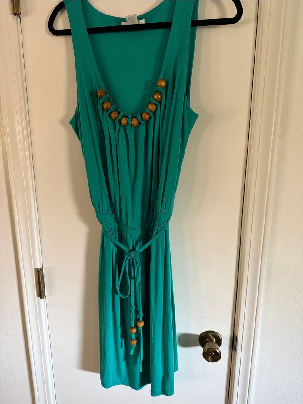 Beautiful sleeveless teal dress with wooden bead accents.